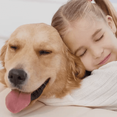 a girl hugging a dog